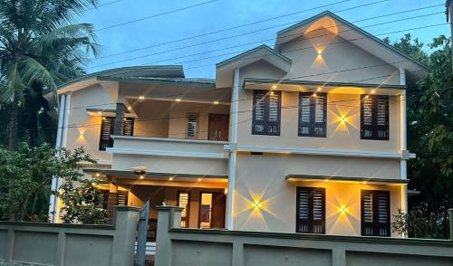 a house with lights on the front of it at Chaithanya Residency Near to NIT in Kunnamangalam