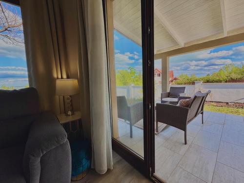 a living room with a sliding glass door to a patio at Azur Villa - Panoramic Escape in Balatonalmádi