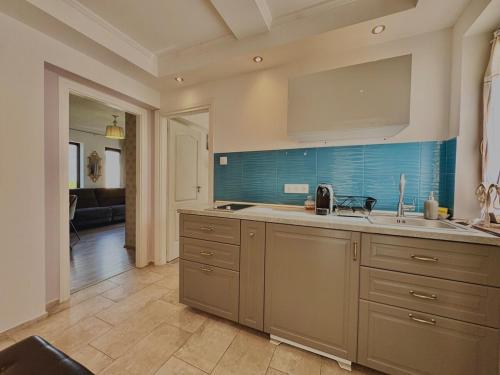 a kitchen with a sink and a counter top at Azur Villa - Panoramic Escape in Balatonalmádi