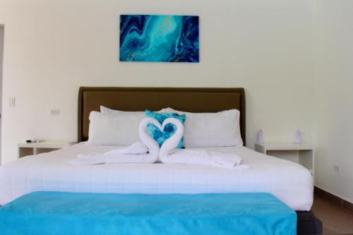two swans made out of towels on a bed at The Views Resort in El Zonte