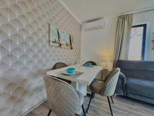 a living room with a table and chairs and a couch at Azur Villa - Panoramic Escape in Balatonalmádi