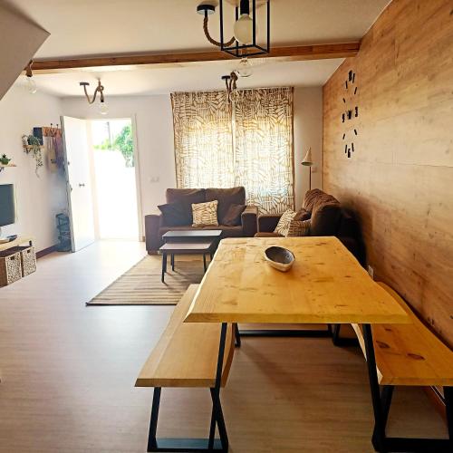 a living room with a table and a couch at Casa frente al mar en Boiro in Magdalena