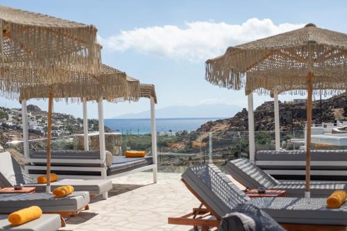 a resort with chairs and umbrellas and the ocean at Paradise View Hotel in Paradise Beach