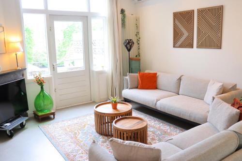 a living room with a couch and a tv at Anna Boutique Apartments in Nijmegen