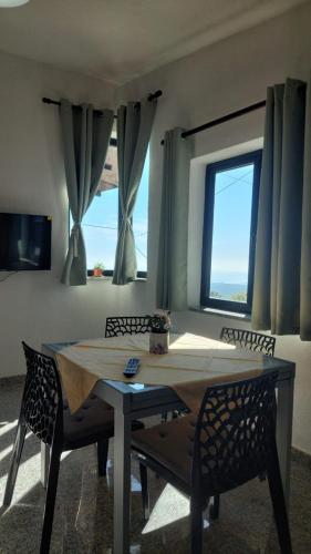 a dining room with a table and chairs and a window at Sa Mesaluna Naturhouse in Ilbono