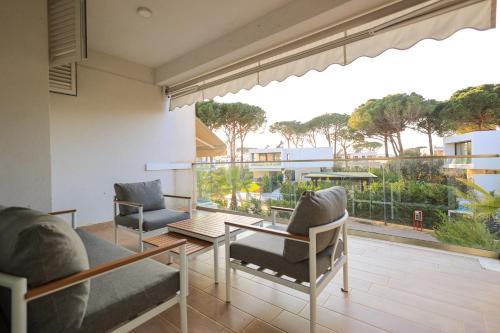 a living room with a table and chairs and a large window at SanPietro Vacation Apartments in Durrës