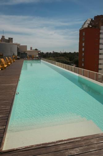 a large swimming pool on the roof of a building at Opta Coliving Punta Carretas in Montevideo