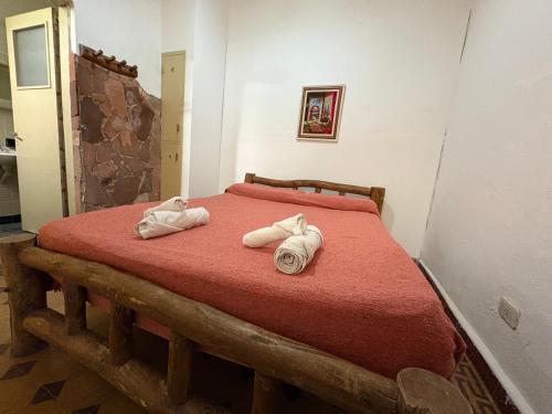 a bedroom with a bed with towels on it at Jujuy Hostel in San Salvador de Jujuy