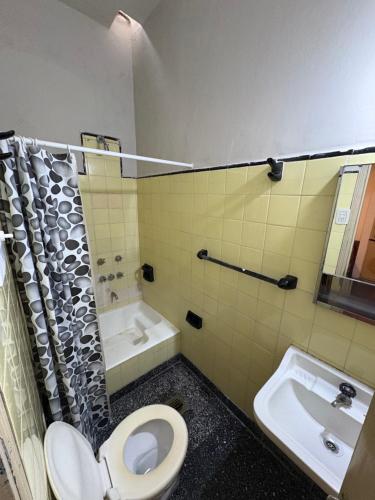 a bathroom with a toilet and a sink at Jujuy Hostel in San Salvador de Jujuy