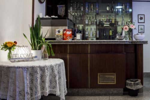 a bar with a table in front of a counter at Hotel La Tripergola in Pozzuoli