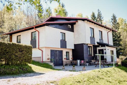 a house with a black and white at Apartmán Pod Žalým in Benecko