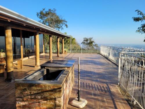 a wooden deck with a fountain on top of a building at Rancho Smaniotto 1783 in Dois Irmãos