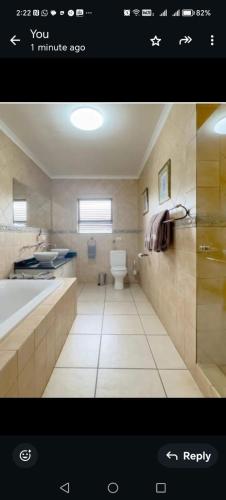 a bathroom with a tub and a toilet in it at Zebula private villa 206 in Vosburg