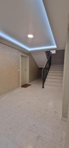 an empty room with a staircase and a ceiling at Apartman Vera in Vrnjačka Banja