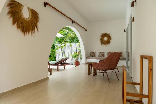 a living room with a table and chairs at Alma Boutique Hotel in Jambiani