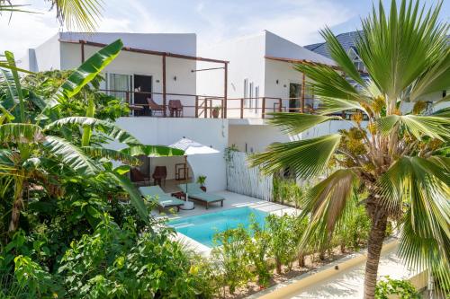 an image of a villa with a swimming pool and palm trees at Alma Boutique Hotel in Jambiani