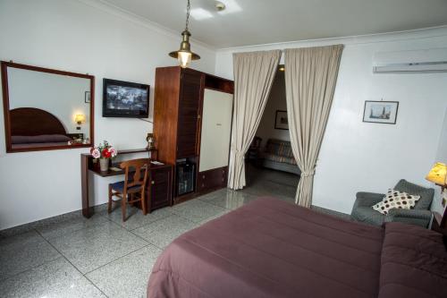 Postel nebo postele na pokoji v ubytování Hotel La Tripergola