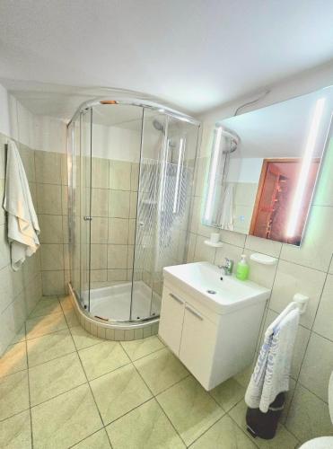 a bathroom with a shower and a sink at Beli Casa in Beli