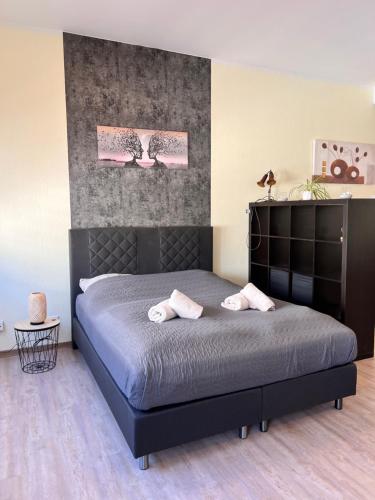 a bedroom with a bed with two towels on it at Loftwohnung Happy Holiday in Herschbach