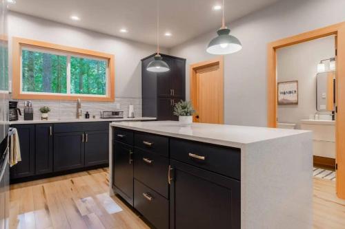 a kitchen with black cabinets and a white counter top at 15GS - Hot Tub - WIFI- Pets Ok in Deming