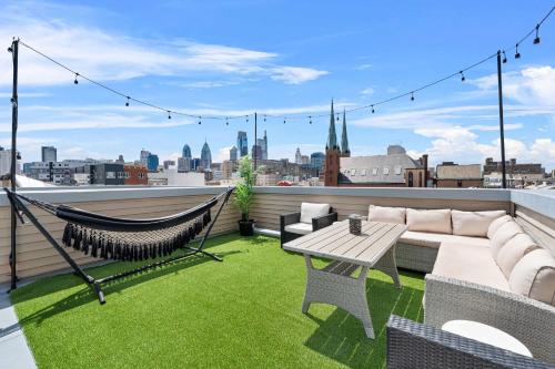 a patio with a hammock and a table on a roof at Brand New Dbl Unit Roofdeck Outdoor Patio in Philadelphia