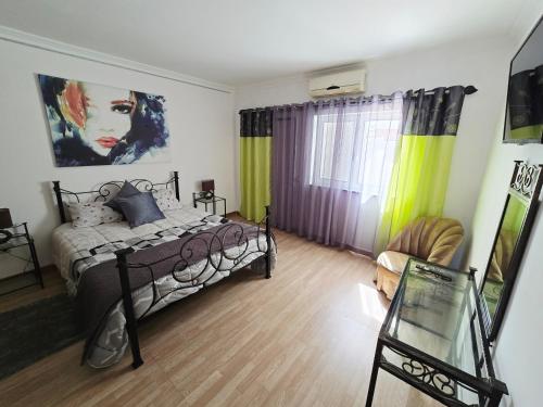 a bedroom with a bed and a painting on the wall at SEAVIEW ALBUFEIRA in Albufeira