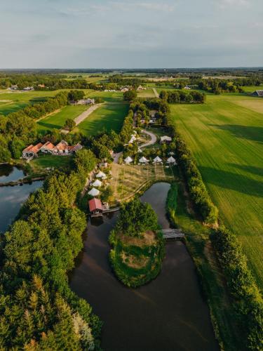 an aerial view of a estate with a bridge over a river at Knus Natuurhuisje met Hottub - Ontspannen in de natuur in Jubbega-Schurega