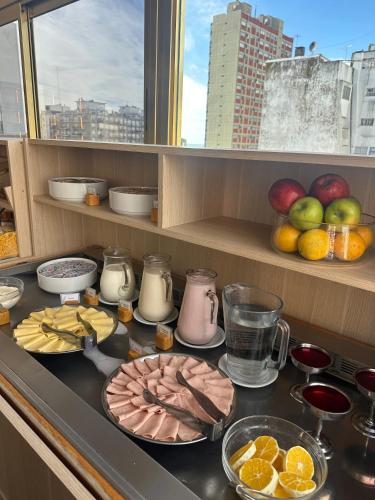 a counter top with food and fruit on it at Hotel Valles in Mar del Plata