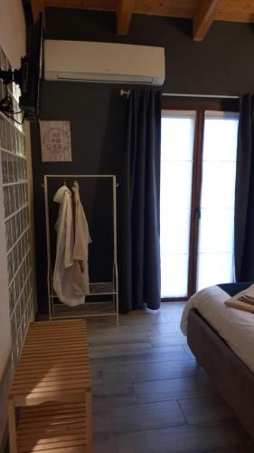 a bedroom with a bed and blue curtains at CORTE DELLA BIRRA - OLDO in Cadelbosco di Sopra