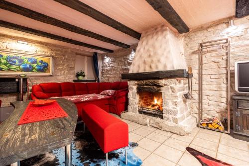 a living room with a red couch and a fireplace at Videviku Villa Apartments in Tallinn