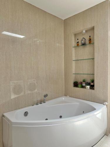 a bathroom with a white tub in a room at Enjoy the A6 house in Sultan Syarif Kasim II International Airport