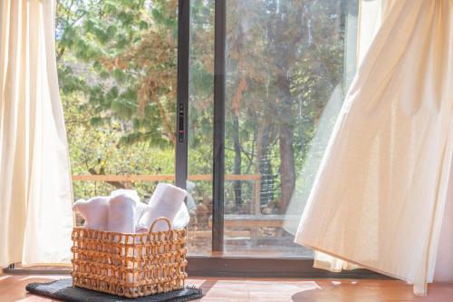 a basket of shoes sitting in front of a window at La Cabaña Rosa in Amealco