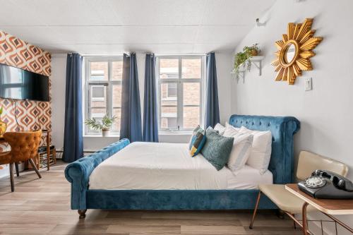 a bedroom with a blue bed with blue curtains at LOFT LE RÉTRO du Centre-Ville in Quebec City
