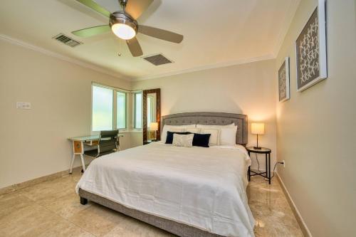 a bedroom with a bed and a ceiling fan at Laguna | Relaxing Family Oasis in Seven Mile Beach