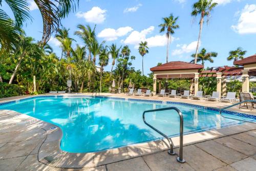 a swimming pool at a resort with palm trees at Laguna | Relaxing Family Oasis in Seven Mile Beach
