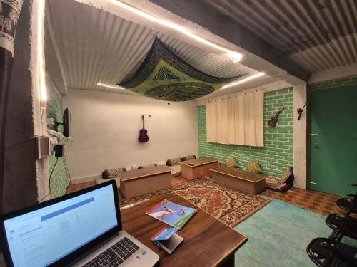 a room with a table with a laptop on it at The Mystic Heaven in Manāli