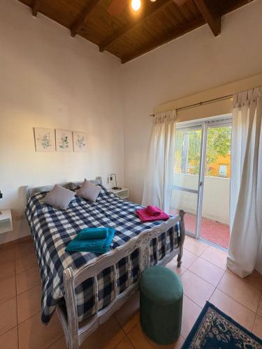 a bedroom with a bed and a large window at Belgrano Calidez Junin in Junín
