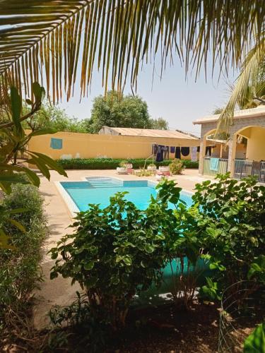 a swimming pool in front of a house at Small air-conditioned apartment with private pool in Warang