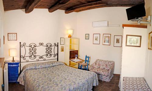 a bedroom with a bed and a chair at Agriturismo Sant'Ilario sul Farfa in Monte Santa Maria