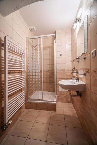 a bathroom with a shower and a sink at Penzión Sobota in Poprad