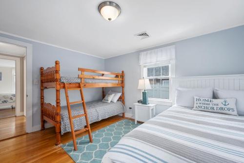 a bedroom with a bunk bed and a ladder at 25 Grey Neck Road West Harwich Cape Cod - - Crosswinds II in West Harwich