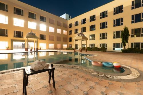 a building with a pool in front of a building at The Sky Imperial, Jaipur in Jaipur
