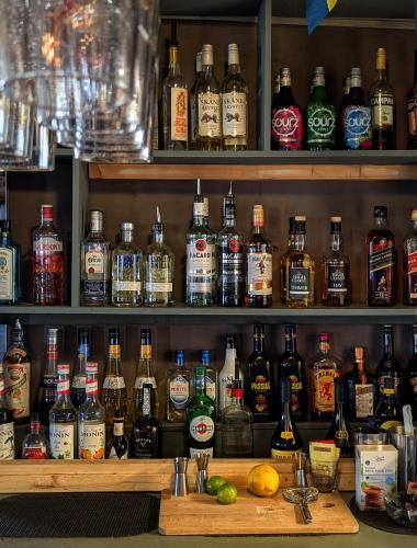 a shelf filled with lots of bottles of alcohol at Brunsbo G:a Biskopsgård Hotell & Konferens in Skara