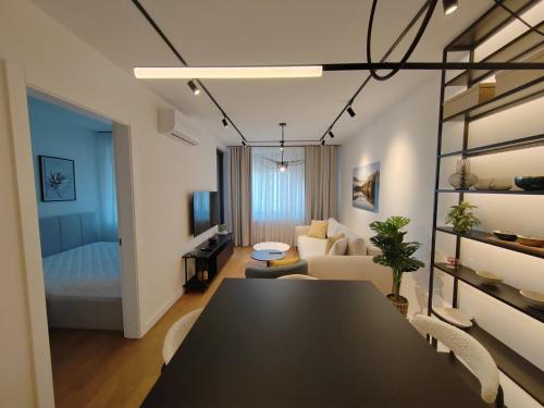 a room with a dining table and a living room at New Luxury Suite with Garrage in Belgrade