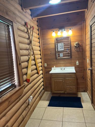 a bathroom with a sink in a log cabin at Bear Necessities located near East Port Marina & Dale Hollow in Alpine
