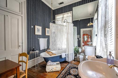 a bathroom with a tub and a sink at Master King Room Victorian with Private Bathroom in a Historic house in Savannah