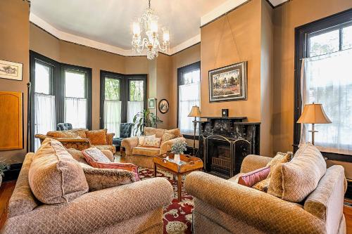 a living room with two couches and a fireplace at Master King Room Victorian with Private Bathroom in a Historic house in Savannah
