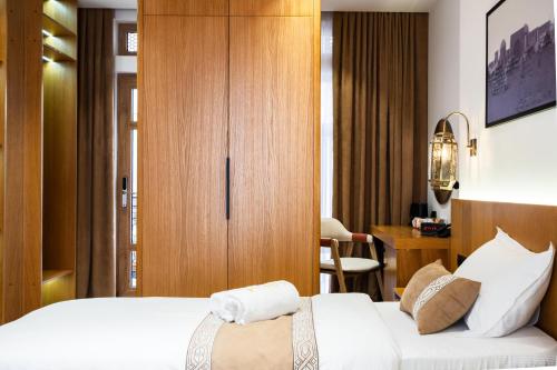 a hotel room with a bed and a desk at Sarhad Hotel in Bukhara