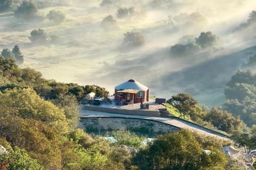 a house on top of a hill with a pool at Mystical Mongolian Yurt in Fallbrook with Views! in Temecula