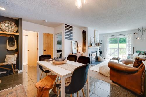 a kitchen and living room with a table and chairs at Ski-InandSki-Out Magic Mountain Condo with Deck! in Londonderry